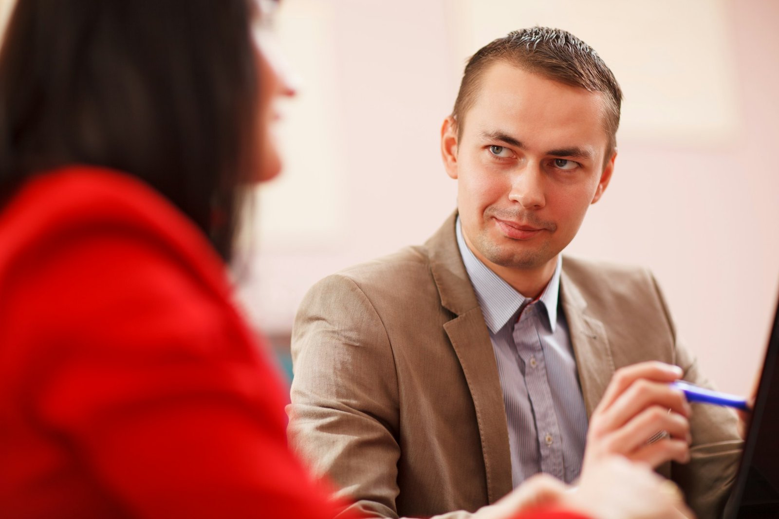 Smiling businessman consulting with a colleague